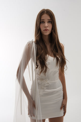 Lightweight cape made of tulle with floral accents and elongated trains