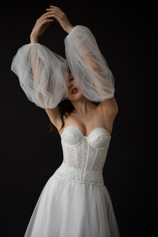 Wedding dress with a sparkling corset and removable voluminous sleeves