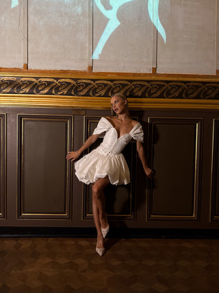 Short dress with a fluffy skirt on a corset — a model with dropped sleeves and a corset base