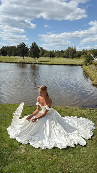Wedding set with corset and skirt made of dark ivory satin with dropped sleeves, lacing at the back, gathering at the bottom, and a train