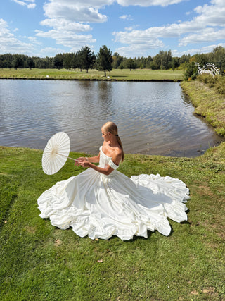 Wedding set with corset and skirt made of dark ivory satin with dropped sleeves, lacing at the back, gathering at the bottom, and a train