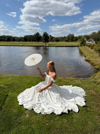 Wedding set with corset and skirt made of dark ivory satin with dropped sleeves, lacing at the back, gathering at the bottom, and a train