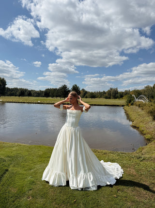 Wedding set with corset and skirt made of dark ivory satin with dropped sleeves, lacing at the back, gathering at the bottom, and a train