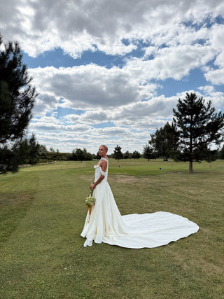 Wedding set with a lace-up corset with dropped sleeves made of chiffon and a fluffy A-line skirt with a long train and a loop for the arms