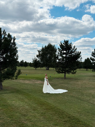 Wedding set with a lace-up corset with dropped sleeves made of chiffon and a fluffy A-line skirt with a long train and a loop for the arms