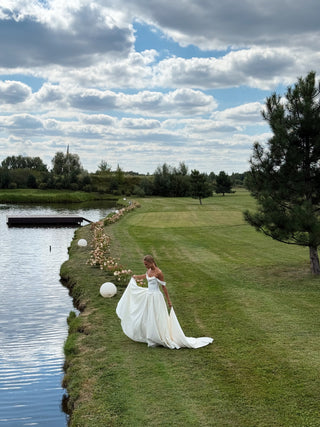 Wedding set with a lace-up corset with dropped sleeves made of chiffon and a fluffy A-line skirt with a long train and a loop for the arms