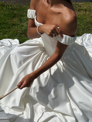 Wedding set with corset and skirt made of dark ivory satin with dropped sleeves, lacing at the back, gathering at the bottom, and a train