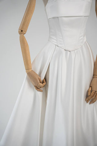 Wedding dress-transformer with a deep cut and a semi-circular long train - designer piece by Caribis