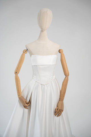 Wedding dress-transformer with a deep cut and a semi-circular long train