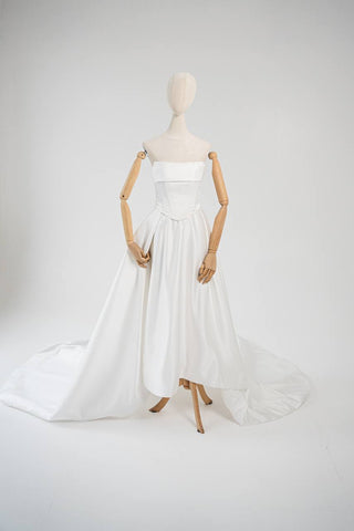 Wedding dress-transformer with a deep cut and a semi-circular long train